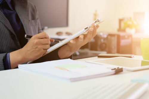 Audit checklist on document board, business working with paper.
